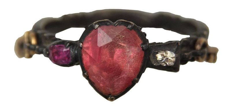 A ring set with a heart-shaped red gemstone