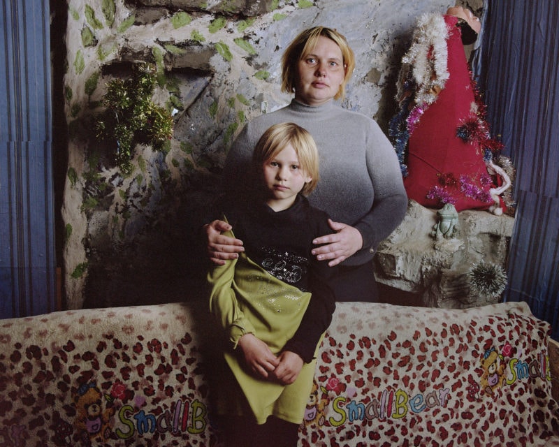 Nataliya and her daughter Nadya, Bylbasivka, 2019. IDP shelters in Ukraine, which are depressingly similar in almost every regard, are frequently located in previously abandoned buildings, be they churches, sanatoria, hospitals, barracks, or schools, and it is the displaced themselves who find ways to make them habitable, as they struggle with extremely poor sanitation, lighting, and heating.  Families are often jammed into tiny rooms, and time and time again it became clear that displacement in Ukraine hits children, the elderly, and the most vulnerable hardest. These are people who often lack the means to access the medicines or treatments they need, who struggle to gain employment, for whom there is no way home and no way out of the camp or shelter.     Through their displacement, individuals disappear from view in both academic and policy discussions about the impact of war on political attitudes and behaviour. They fall outside standard opinion polls, they do not figure in international media reports (and hardly figure in the Ukrainian media), and in policy circles they are primarily seen as a social policy or humanitarian aid issue. This is even more the case when the displaced person is a child.