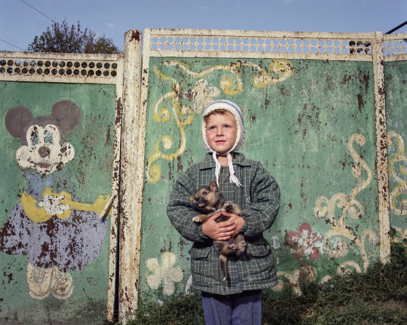 Boy with dog, Troitske, Luhansk, 2019. 