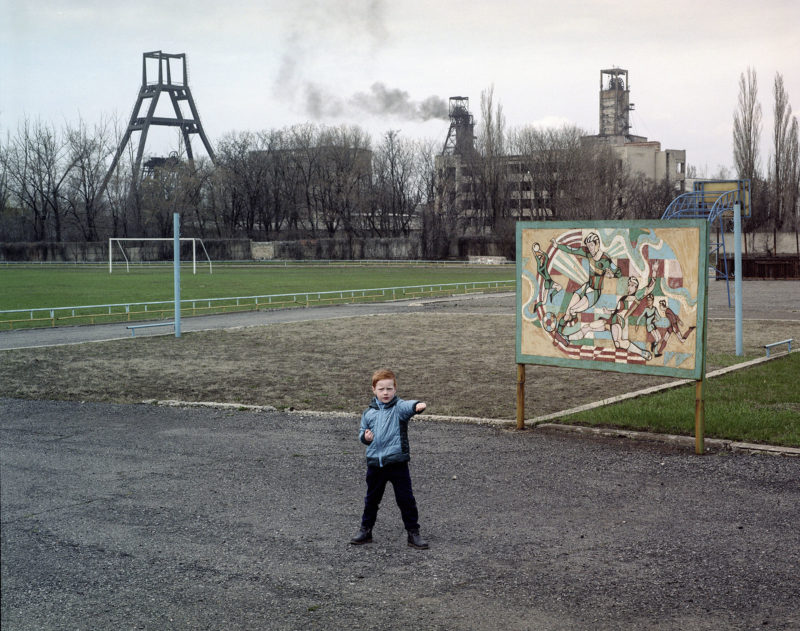 Boy outside in Ukrainsk, Donetsk, 2021. 