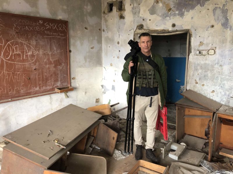 Mark Neville, in a war damaged classroom.
